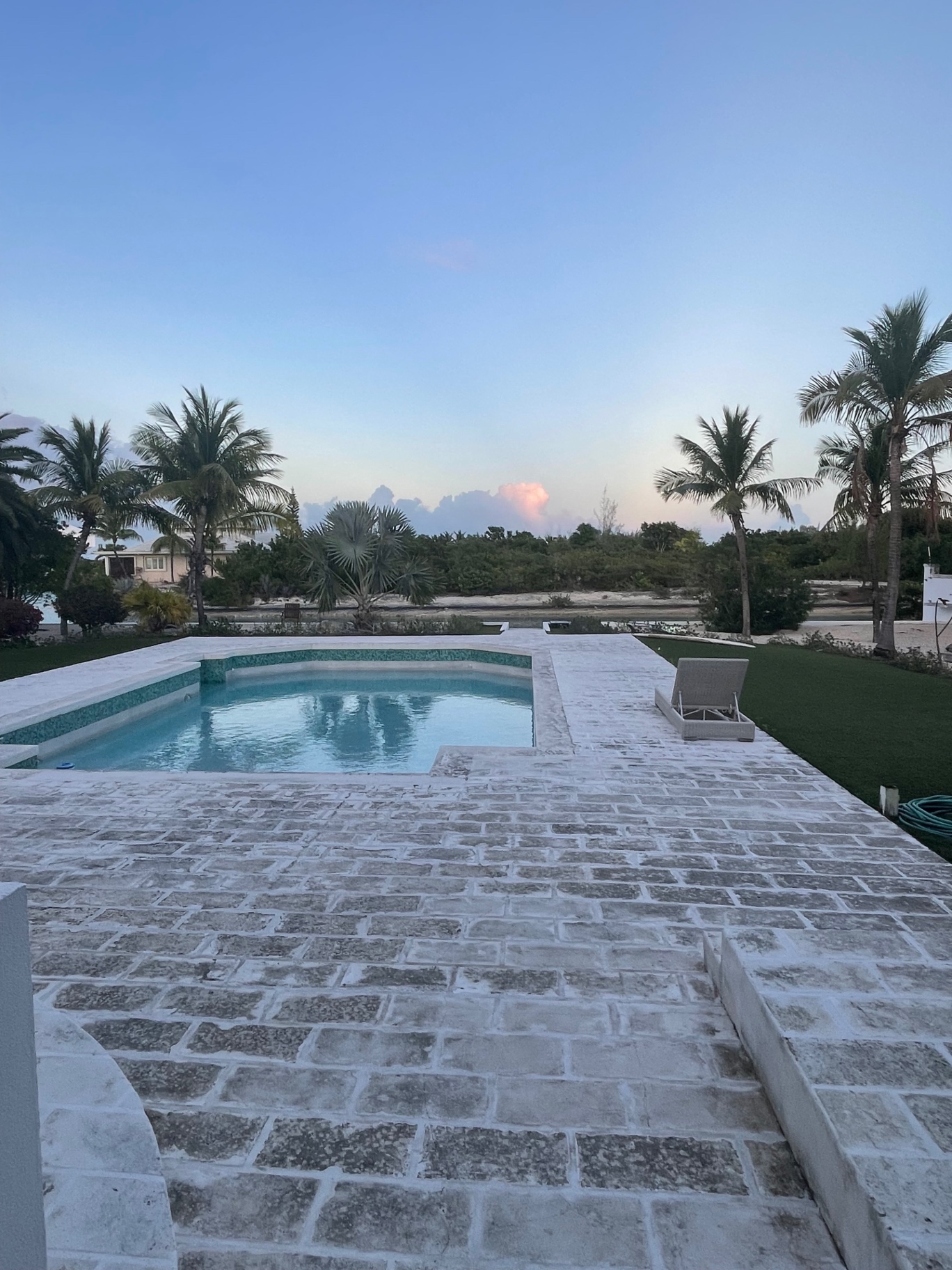 Pool and palms at dusk in Turks and Caicos