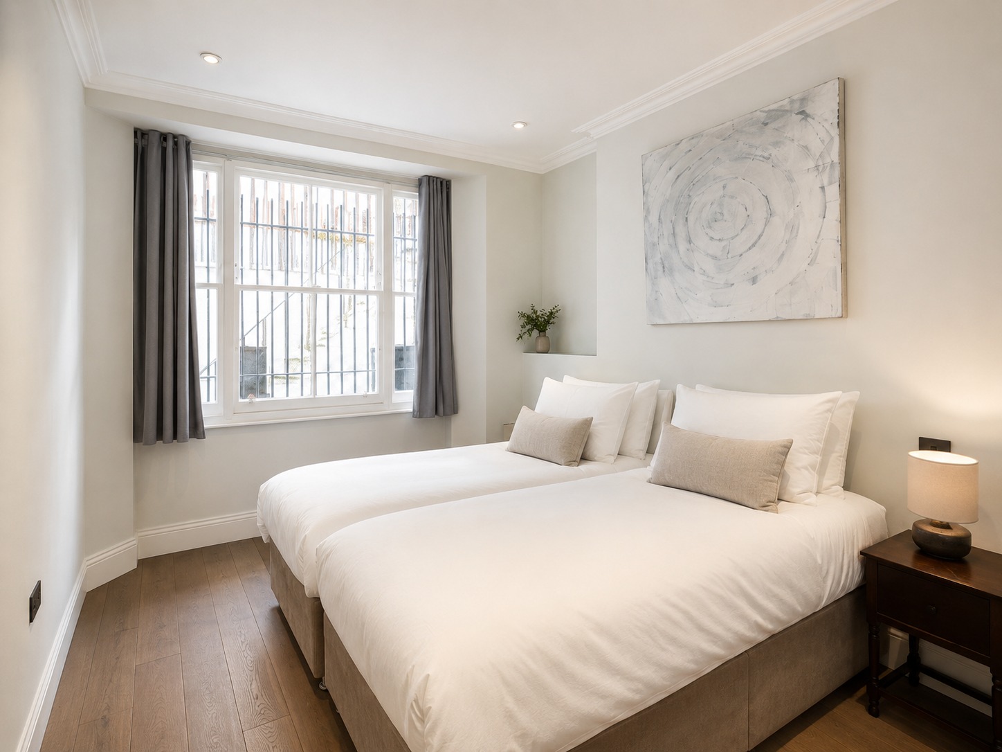 A pale circular painting in a bedroom