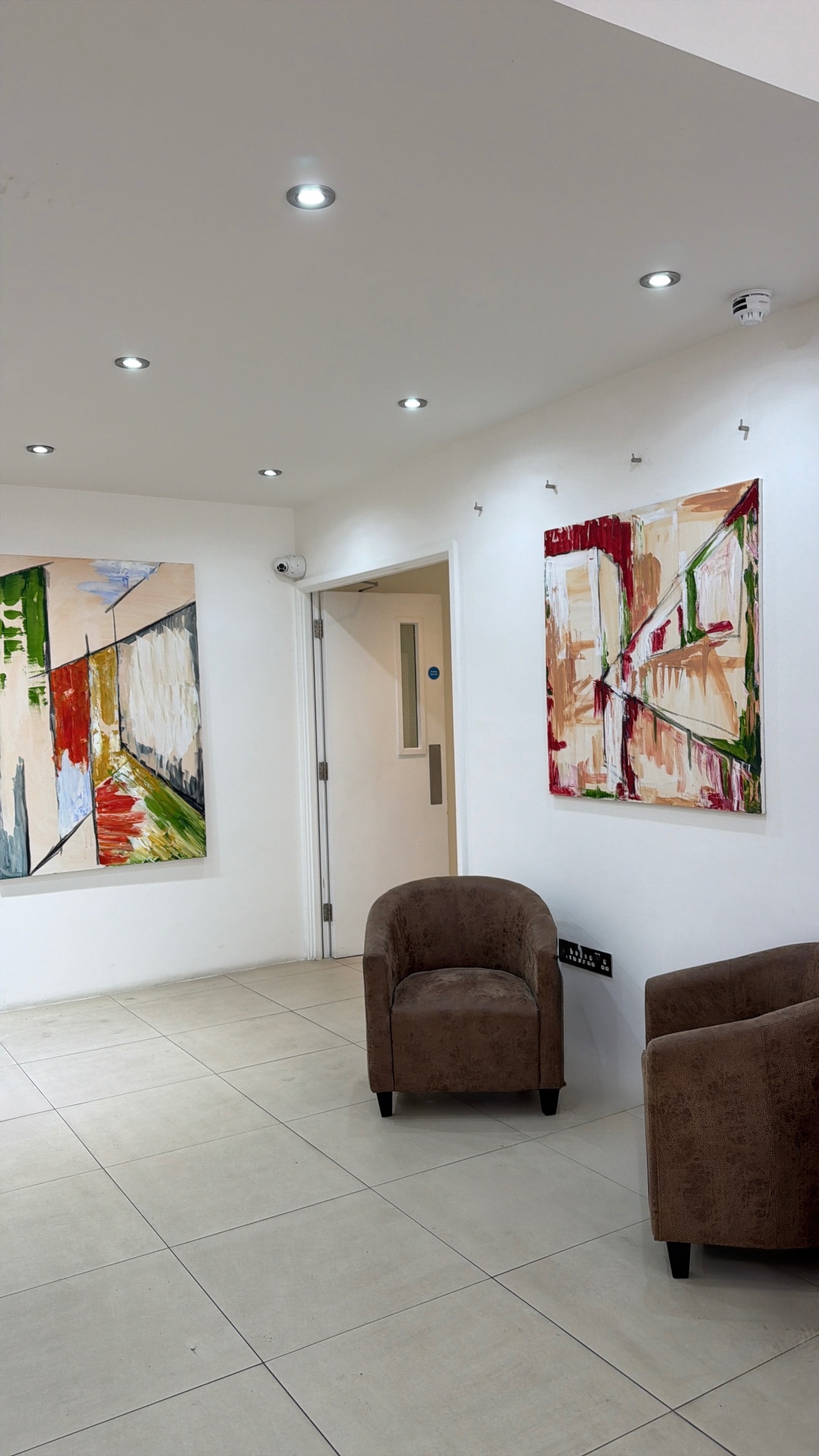 Two paintings framing the entrance lobby at Easy Hub, Chelsea
