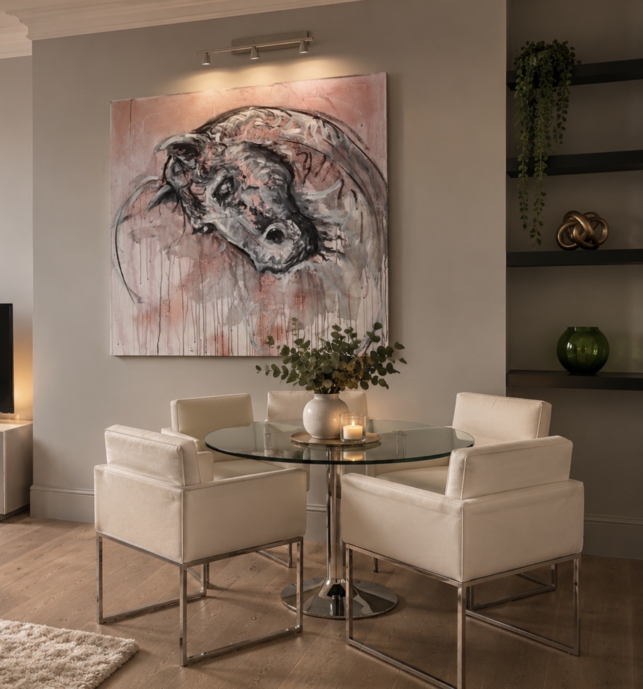 A large painting above a round dining table