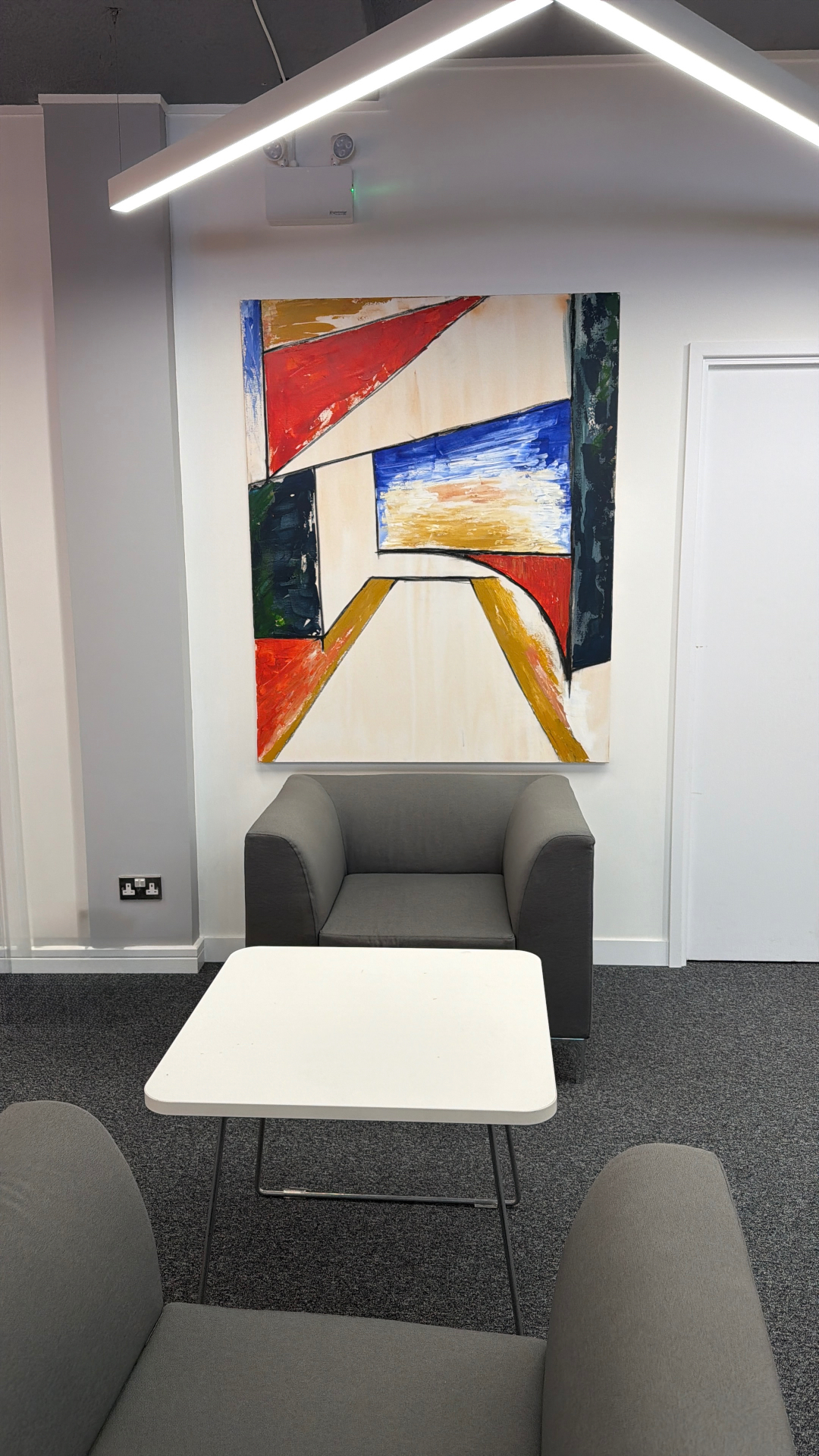 A large canvas above the seating area at Easy Hub, Chelsea