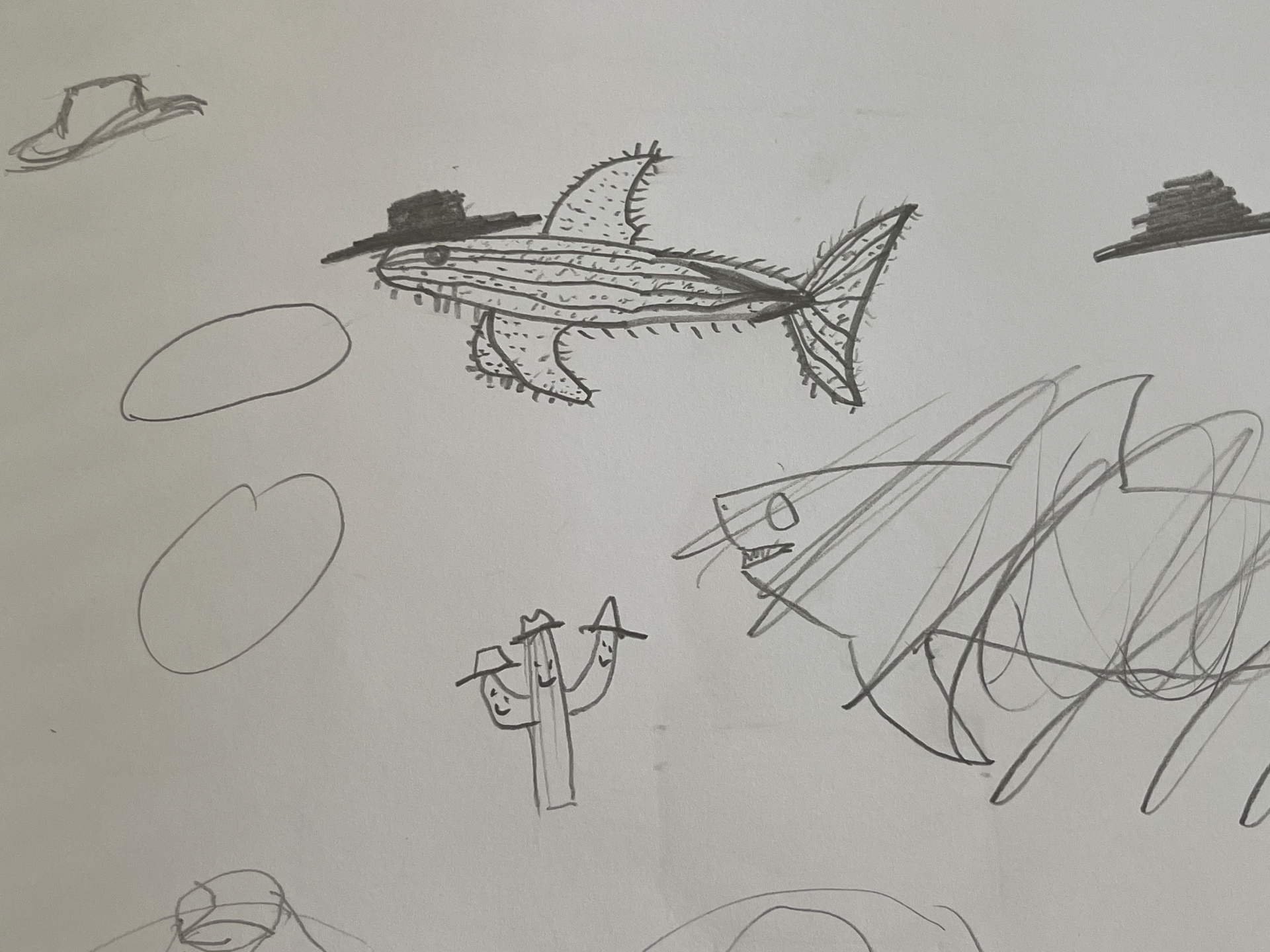 Sketchbook page of sharks, cacti and desert forms in pencil