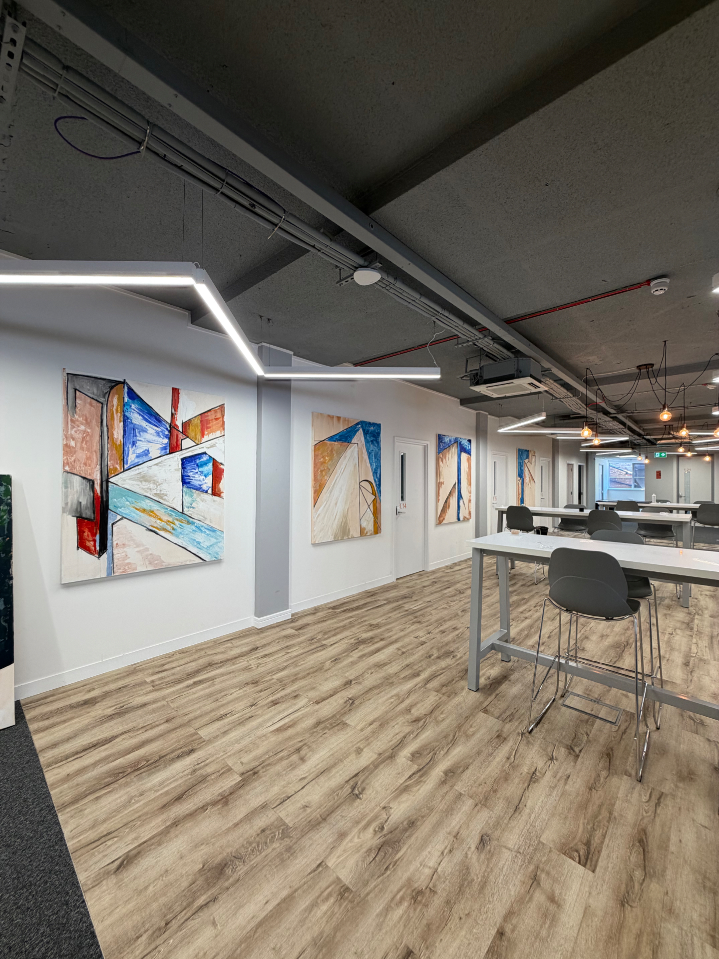 Paintings installed along the main working floor at Easy Hub, Chelsea